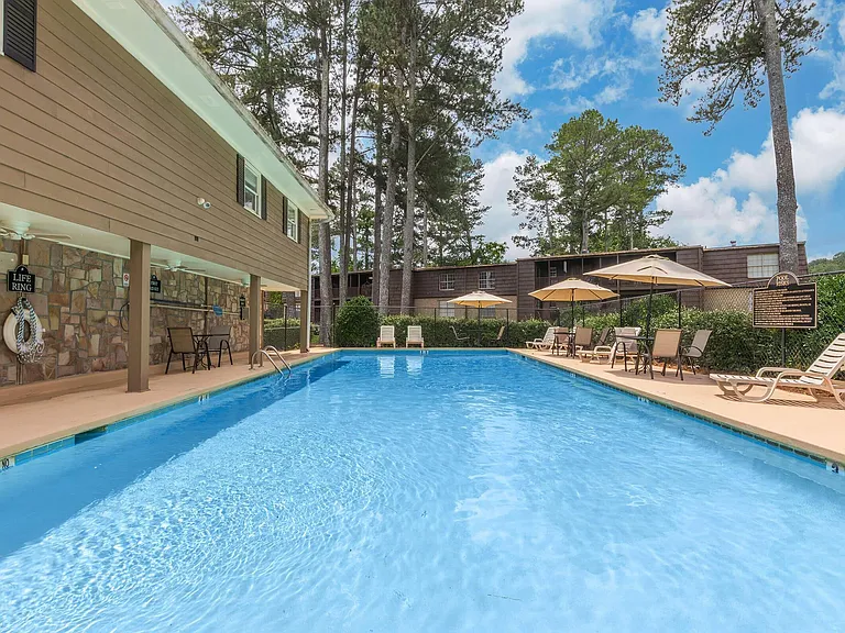 Welcome to Guest House, where relaxation meets sophistication. Dive into our inviting pool surrounded by lush landscaping and comfortable seating. Enjoy a serene escape right at home. Schedule a tour today to see it for yourself!