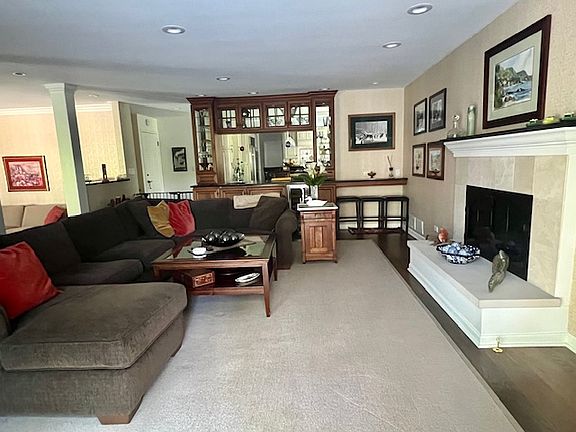 Relaxing Family room can host a family of 6 comfortably. California watercolor art work is featured on the walls. Sliders go out to the blue stone patio.