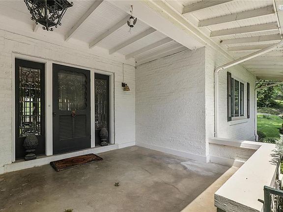 Large covered front porch with beautiful leaded glass door and side lights.