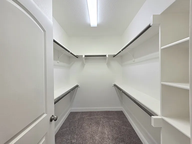 1 of 2 closets in Primary bedroom