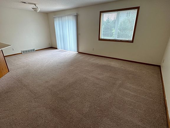 Living room/dining room/patio door off from kitchen on main floor.