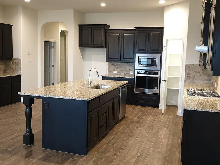 The kitchen is equipped with 4 burners gas stove, large granite island bar, SS appliances, walk-in pantry and a Butler's pantry