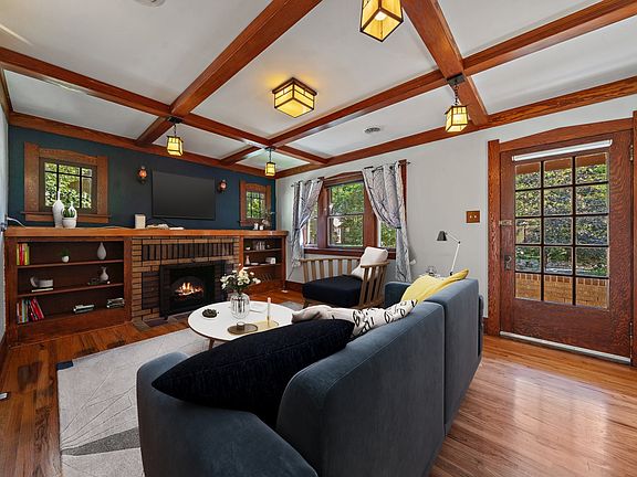 Living room with beams and tons of light. Built in bookshelves, sconces etc