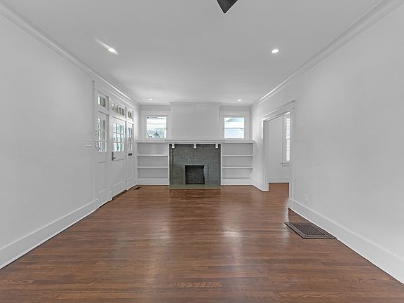 Large Living area with built-ins and ceiling fan