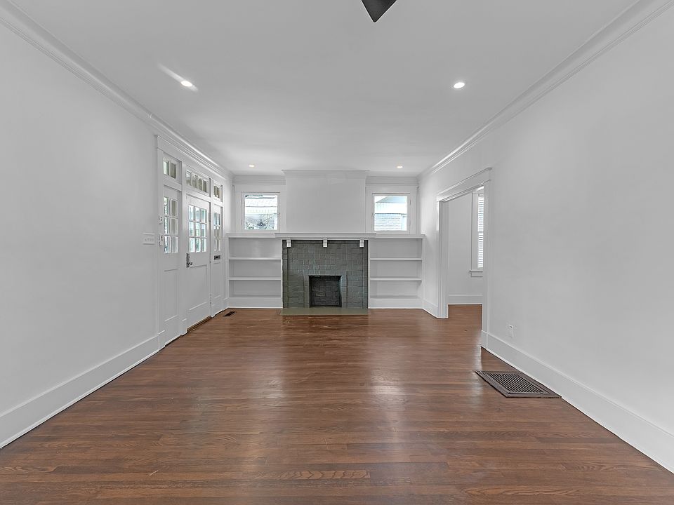 Large Living area with built-ins and ceiling fan