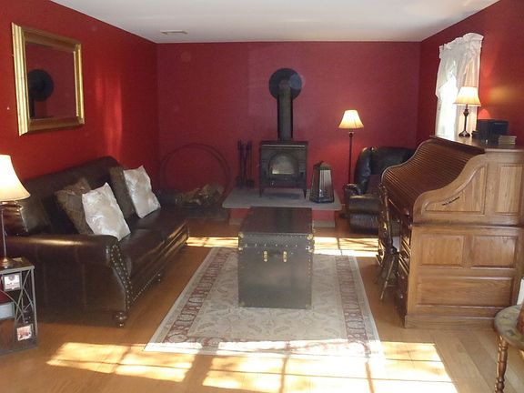 Comfortable formal living room : Wood flooring with wood stove to keep the house toasty on cold wint