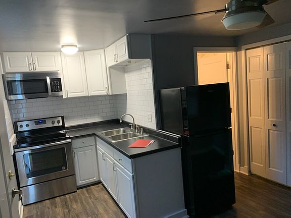 full kitchen view w/ partial view of full size closet