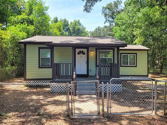 Fenced in yard with mature shade trees