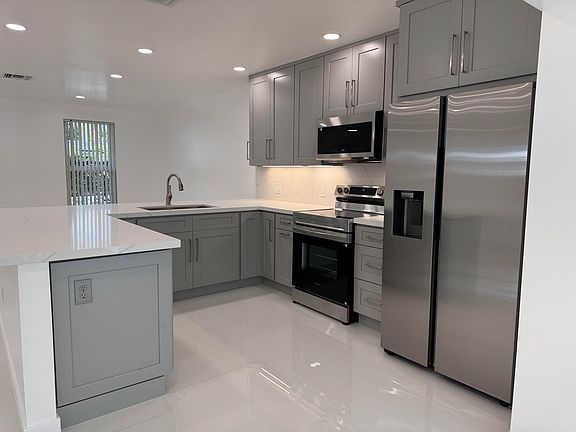 The kitchen with all new appliances, all new cabinets and brand new quartz counter tops.