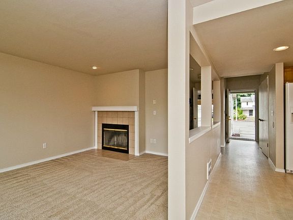 From the back yard door, you can see the living room, hallway and kitchen thoroughfare to the front door. The left side of the partition behind the fireplace wall is the utility room and 1/2 bath. Beyond that is the doorway to the garage. There's also a storage closet and a clothes closet as you enter!