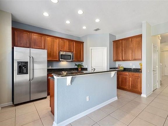 Open Kitchen offers a granite breakfast bar, stainless steel appliances, walk in pantry and plenty of granite counter top worksp
