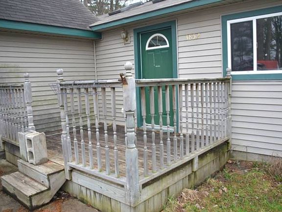 The front entrance has deck that leads you up to the front door.