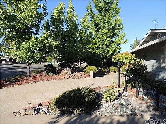 Mature trees screen the home from the street