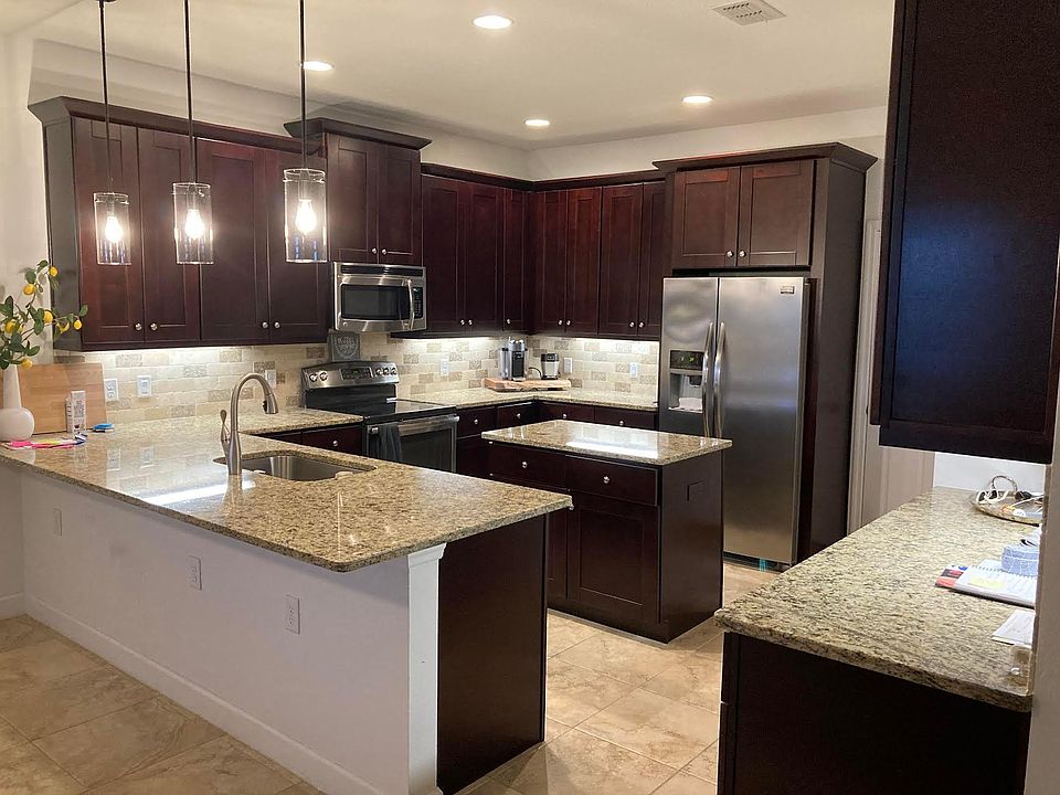 Kitchen; counter top for seating. Appliances: Dishwasher, Stove, Microwave, Refrigerator, Beverage cooler