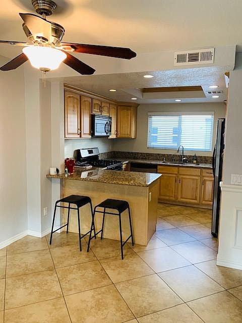 Granite countertops, large island + lots of storage!