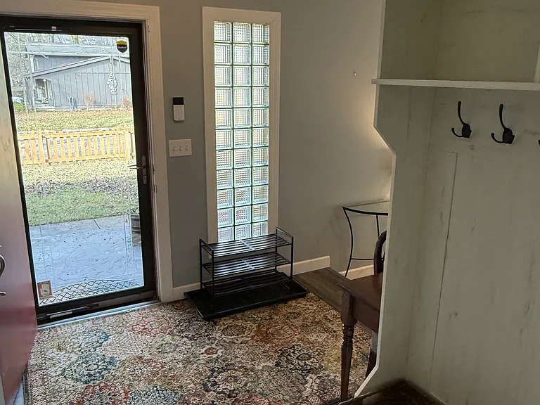 Entry way with storm door, coat rack and storage cubbies