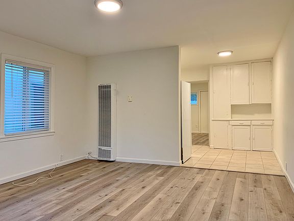Living Room; stock photos. Available unit has luxury vinyl "wood" plank flooring throughout except in the bathroom.
