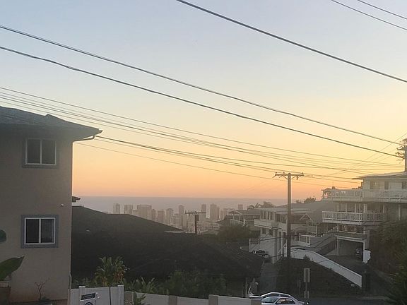 View of city and ocean from living room