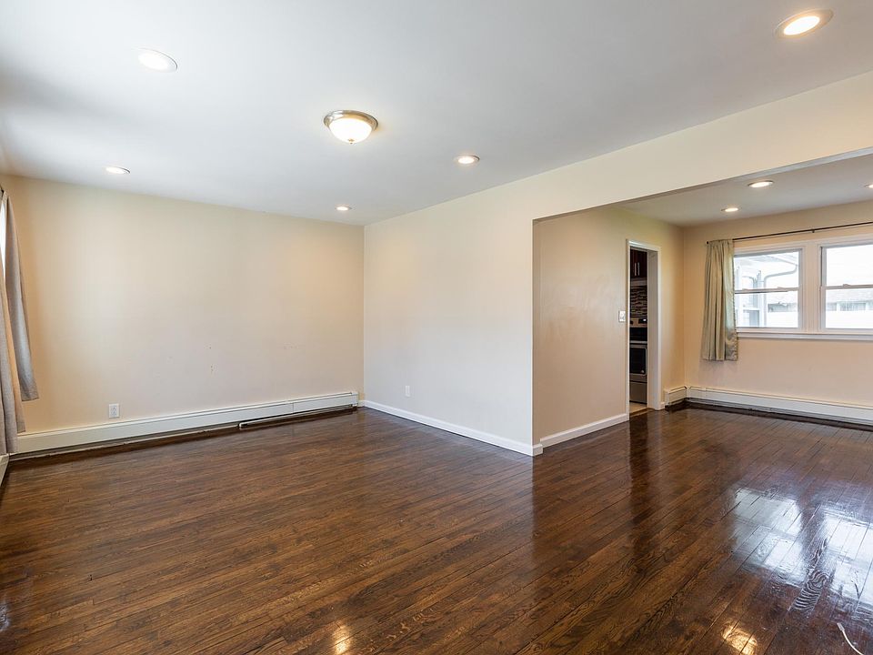 Very Spacious Living Room with Glistening Hardwood Floors Throughout House!