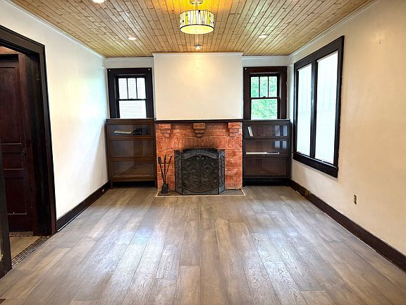 living room with wood burning fireplace, two barrister bookcases that stay with the house