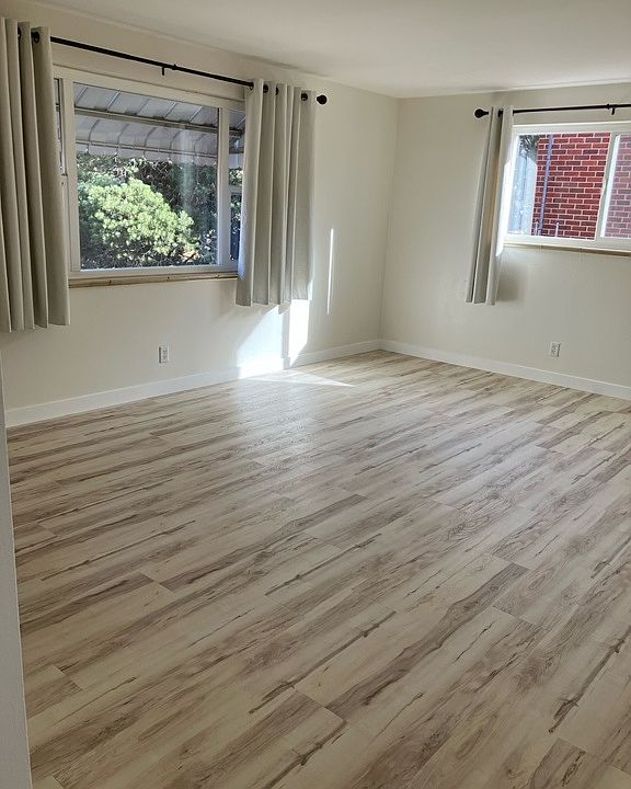 Spacious living room with lots of light and included curtains