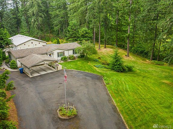 Aerial view of the front part of the property with the 2400 sqft shop in the background.