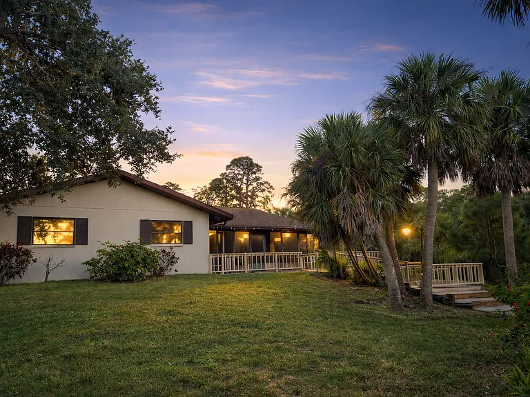 Back of house with deck and lanai