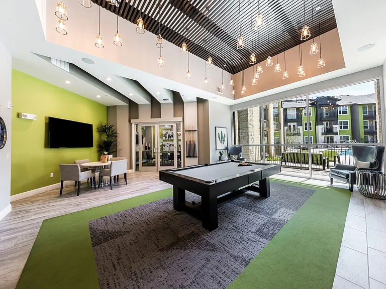 Game lounge with pool table and pool view