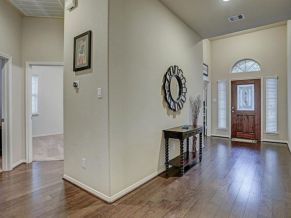 View to entry and secondary bedrooms. This home is all about the great spaces and convenience of living.