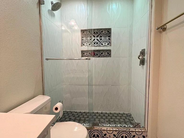updated bathroom with dual shower heads