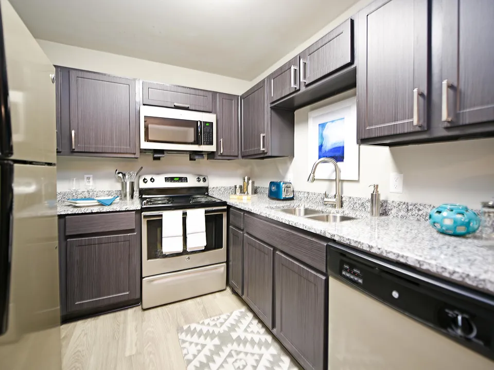 Kitchen with granite counters, stainless appliances, and modern cabinetry