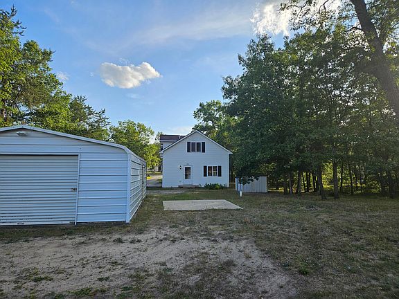 From the large back yard looking toward your unit. Notice the garage. It is available for use but has a leak in one side of the roof so I don't list it as a perk.