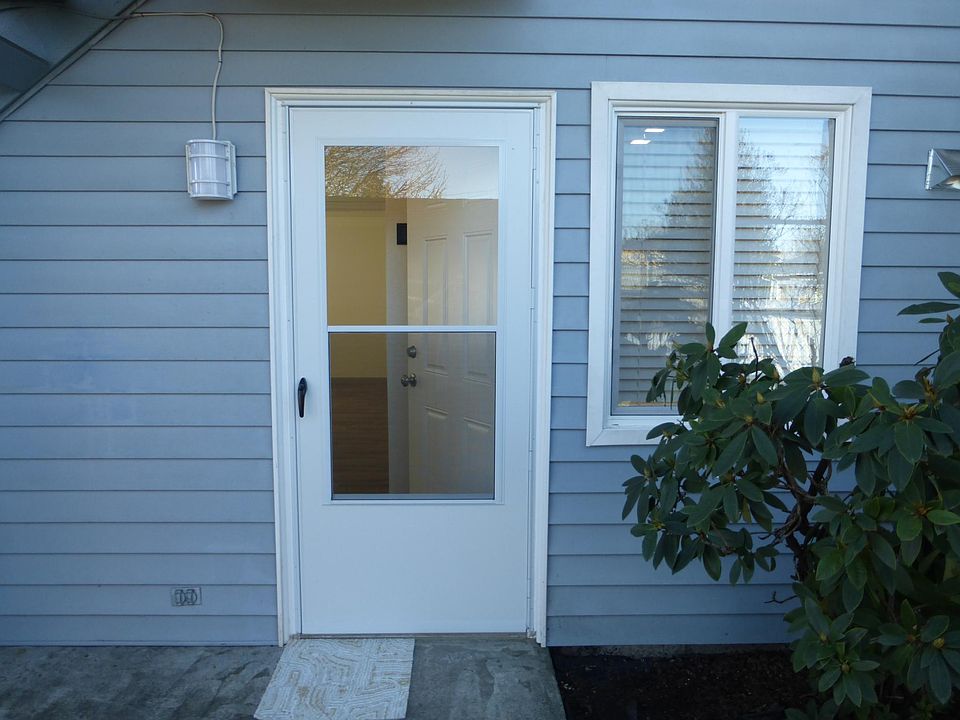 Entry door with cheery kitchen window.