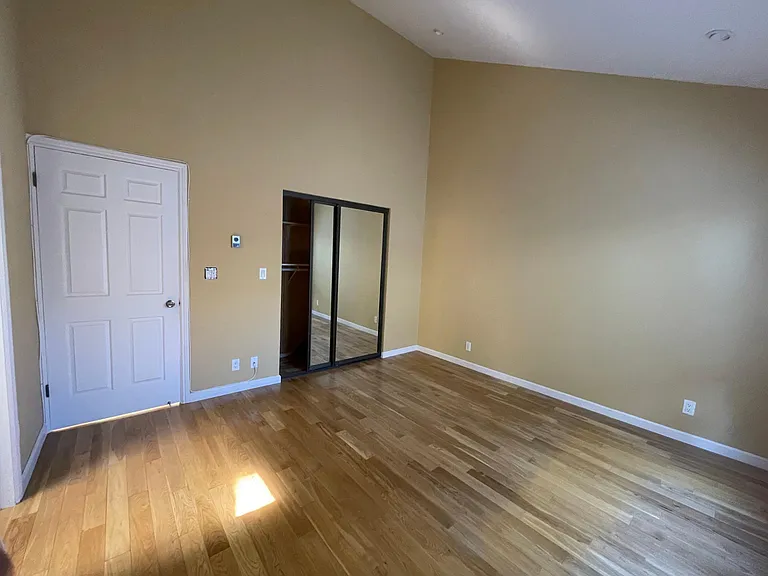 master bedroom with mirror closet and bathroom