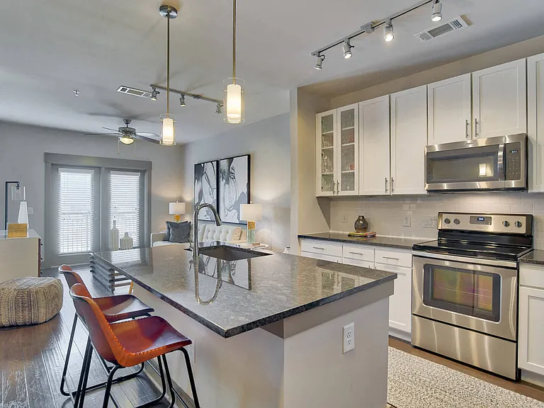 Kitchens feature granite countertops and custom maple cabinetry