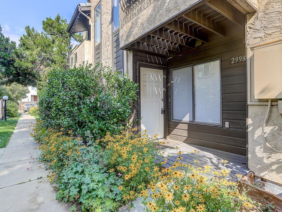 South Entrance - Patio - Master Bedroom Balcony - Reserved Parking Space can be seen where the car is located.