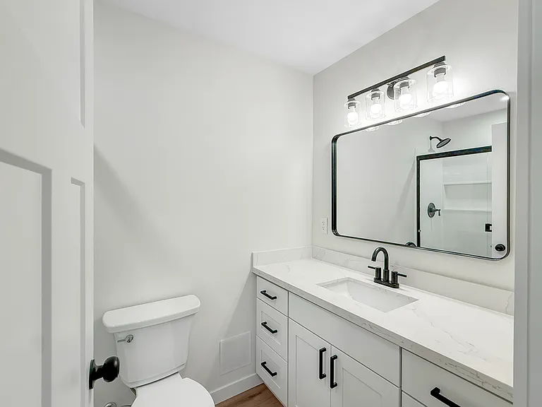 Nice walk in shower & large vanity with lots of storage.