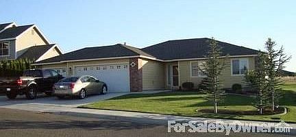 front of home : brick trim, wood siding, front storm door
