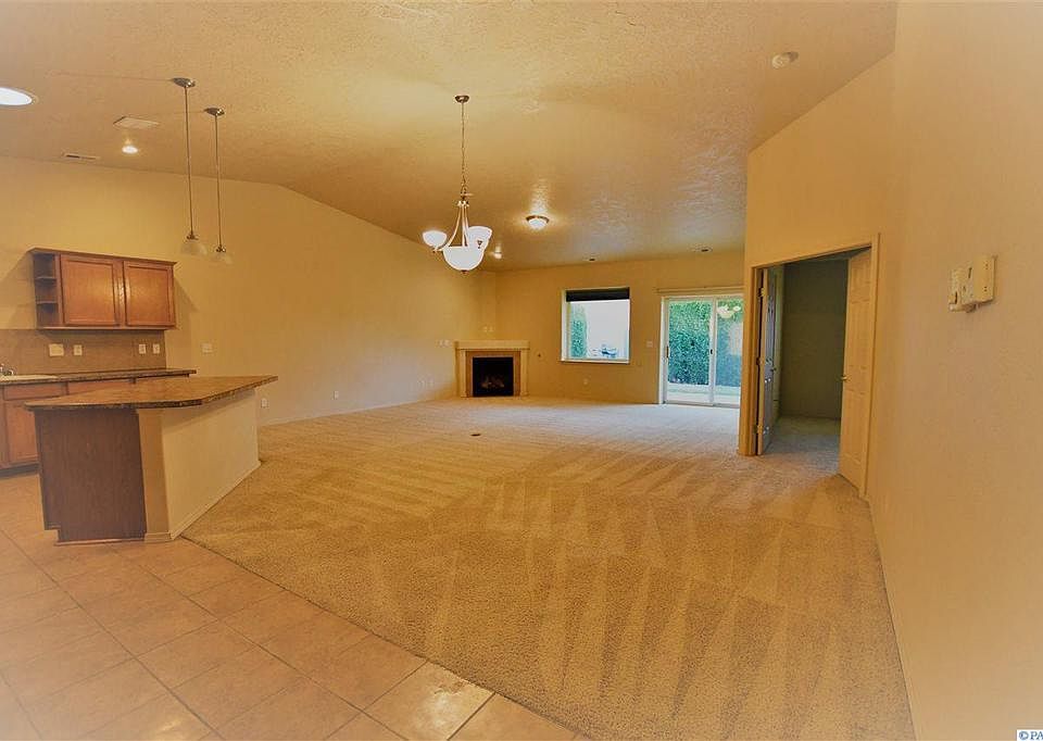 living room. Carpet has been replaced by new hard wood floor.