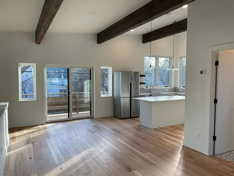 beautiful maple floors, exposed beams and large windows everywhere