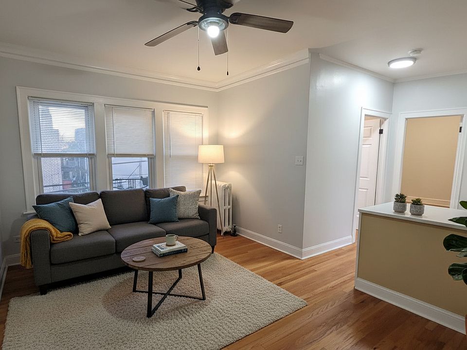 Updated living room with abundant natural light. Features a modern ceiling fan and an open layout perfect for relaxing or entertaining.