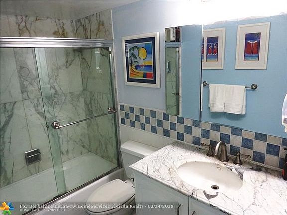 Updated master bath with marble counter top.