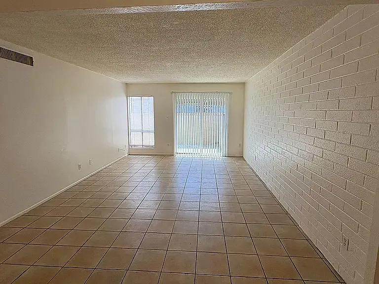 Large living room with tile and slider to private partio