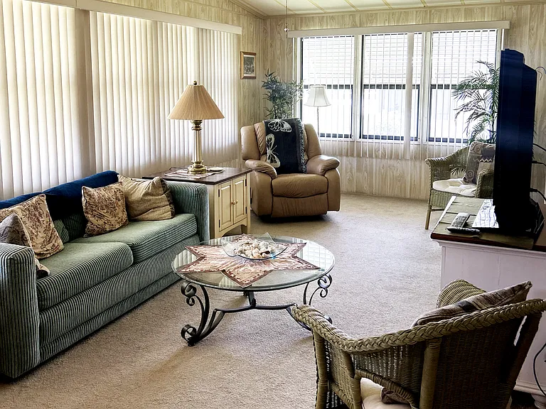 Large Living Room with second pullout couch, recliner, tv, and wet bar.
