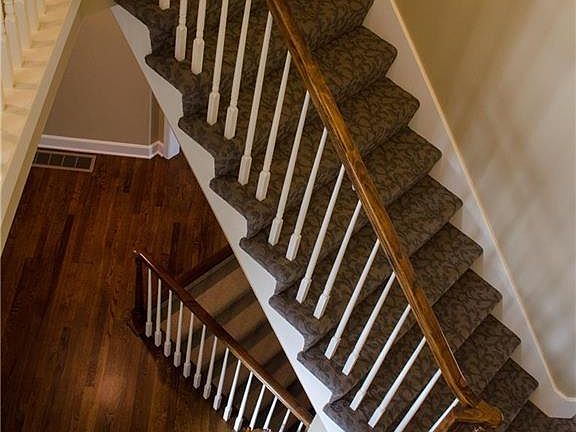View from 2nd level of the UNIQUE staircase featuring NEW designer carpet and dual access from main entry & kitchen