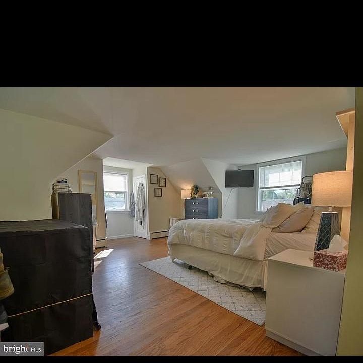 Large master bedroom with 2 closets, hardwood floors an good natural lighting