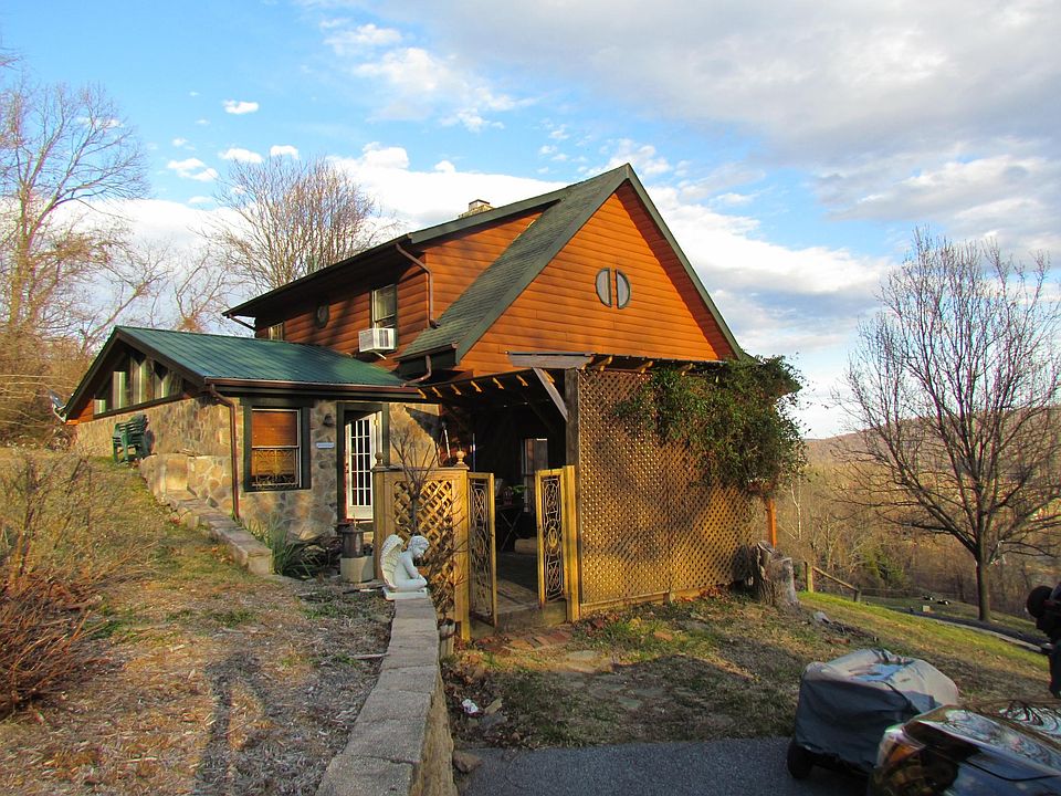 view of log and stone home