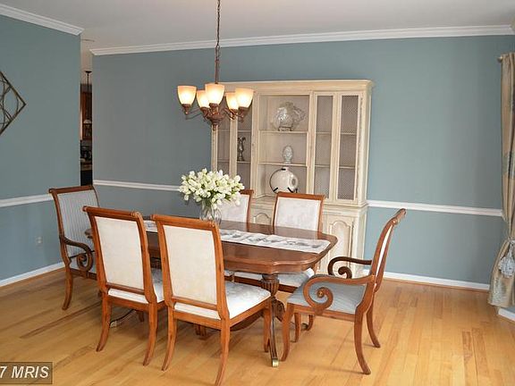 Dining Room with hardwood and bay window