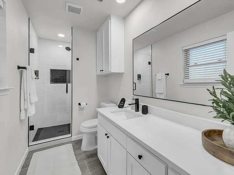 Large mirror, lots of cabinet space and countertop space