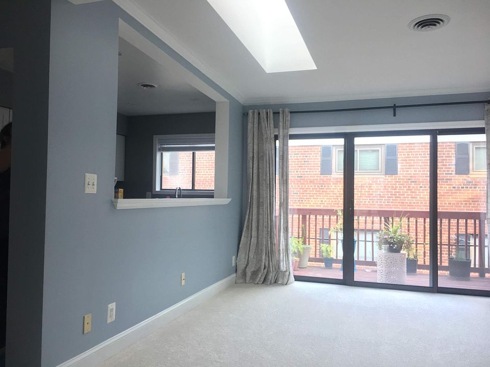 Living room with skylights, deck, and pass thru to kitchen.